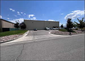 View of property exterior with uncovered parking
