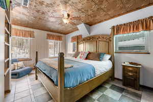 Bedroom featuring an ornate ceiling and ceiling fan