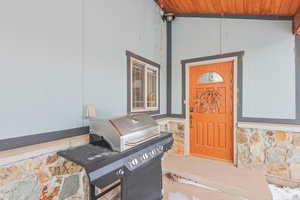 View of exterior entry with stone siding