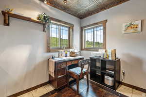 Home office featuring an ornate ceiling, healthy amount of natural light, and tile patterned floors