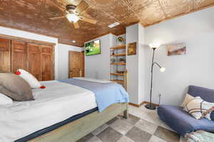 Bedroom featuring an ornate ceiling, a ceiling fan, a closet, and ornamental molding