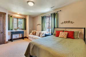 Carpeted bedroom featuring baseboards