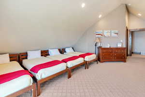 Bedroom with light carpet, recessed lighting, and high vaulted ceiling