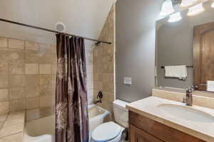 Full bathroom featuring shower / tub combo and vanity