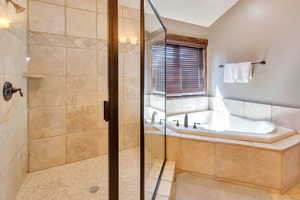 Bathroom featuring a stall shower and a garden tub