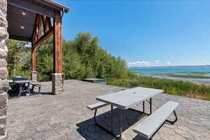View of patio with a water view and outdoor dining space