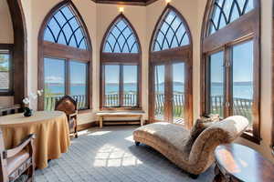 Turret featuring French doors and a water view
