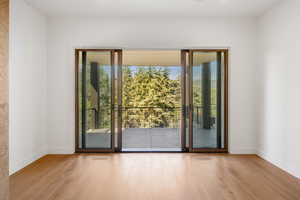 Doorway to outside featuring plenty of natural light and wood finished floors
