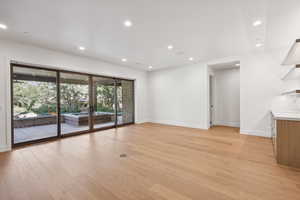 Unfurnished living room with recessed lighting and light wood-style flooring