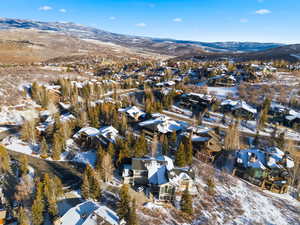 Snowy aerial view with a mountain view and a residential view