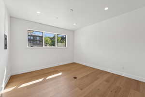 Unfurnished room with light wood-style flooring and recessed lighting