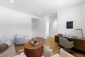 Office featuring light wood-style floors, recessed lighting, and attic access