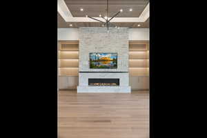 Unfurnished living room with light wood-style floors, recessed lighting, a fireplace, and wooden ceiling