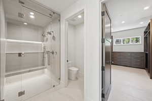 Full bath featuring recessed lighting, a shower stall, and light tile patterned floors