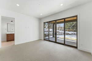 Spare room featuring light colored carpet and recessed lighting