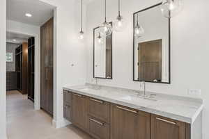 Full bathroom featuring double vanity and recessed lighting