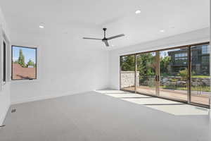 Empty room featuring carpet floors, recessed lighting, and a ceiling fan
