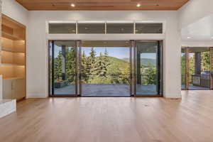 Doorway featuring wood finished floors, a mountain view, recessed lighting, wooden ceiling, and built in features