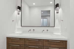 Full bath featuring double vanity and recessed lighting
