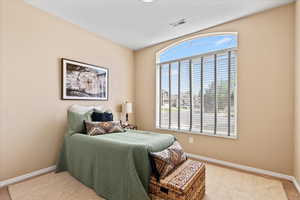 Carpeted bedroom featuring baseboards