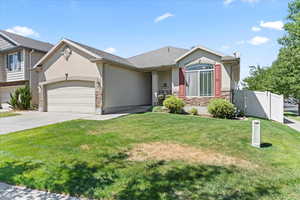View of front of house featuring stucco siding, stone siding, driveway, and a garage