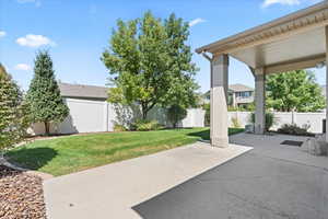 Fenced backyard with a patio area