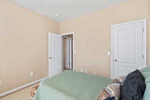 Carpeted bedroom with baseboards