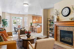 Living room with a tile fireplace and a chandelier