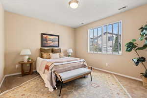 Bedroom featuring carpet flooring and baseboards