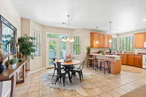 Dining space featuring light tile patterned flooring and a chandelier