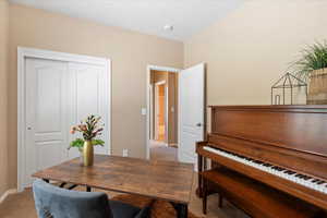 Office area featuring light colored carpet and baseboards