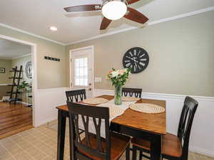 Dining space with ornamental molding, light tile patterned flooring, recessed lighting, and ceiling fan