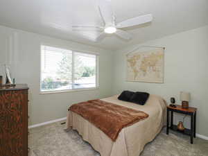 Bedroom with light carpet and ceiling fan