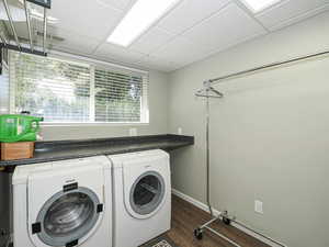 Laundry area featuring washer and dryer and dark wood-style floors