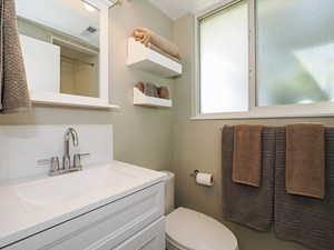 Bathroom featuring vanity and toilet