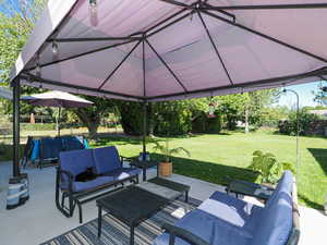Fenced backyard with an outdoor hangout area and a patio