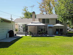 Back of house featuring a covered patio area, and a gazebo,