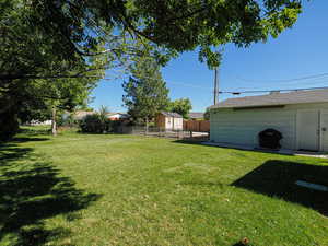 Fenced backyard with mature trees