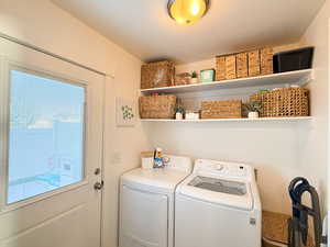 Laundry room featuring a textured ceiling and washing machine and dryer