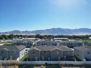 View of mountain backdrop featuring nearby suburban area