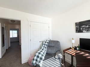 Office with carpet and a textured ceiling