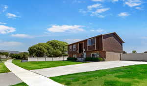 View of front facade featuring brick siding