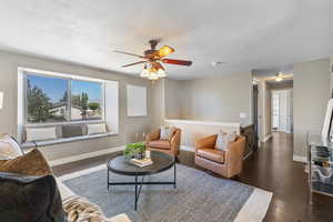 Living room featuring a ceiling fan and wood finished floors