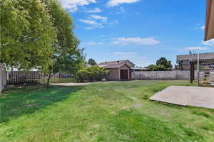 Fenced backyard with a patio area