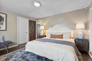 Bedroom with baseboards and wood finished floors