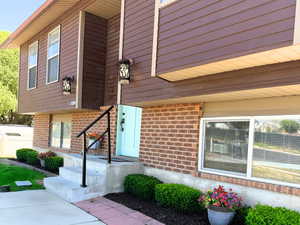 Entrance to property with brick siding