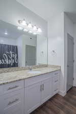 Bathroom with vanity and dark wood-style floors
