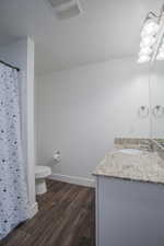 Bathroom with vanity, dark wood-type flooring, and a shower stall