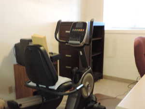 Office featuring built in desk and cabinets