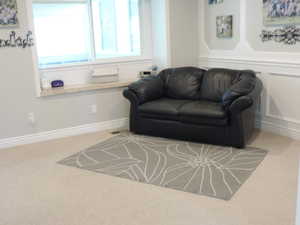 Living room featuring light carpet and baseboards